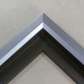 Unique geometric 1 " floater. The face of this molding features an off center peak which gives it a unique contrast in the right lighting. This frame comes in Metallic Blue Pewter with a dull satin finish.